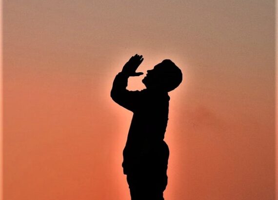 a man standing praying